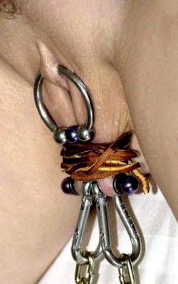 Large Ring In Clithood, Bar With Shackles Through Labia.
