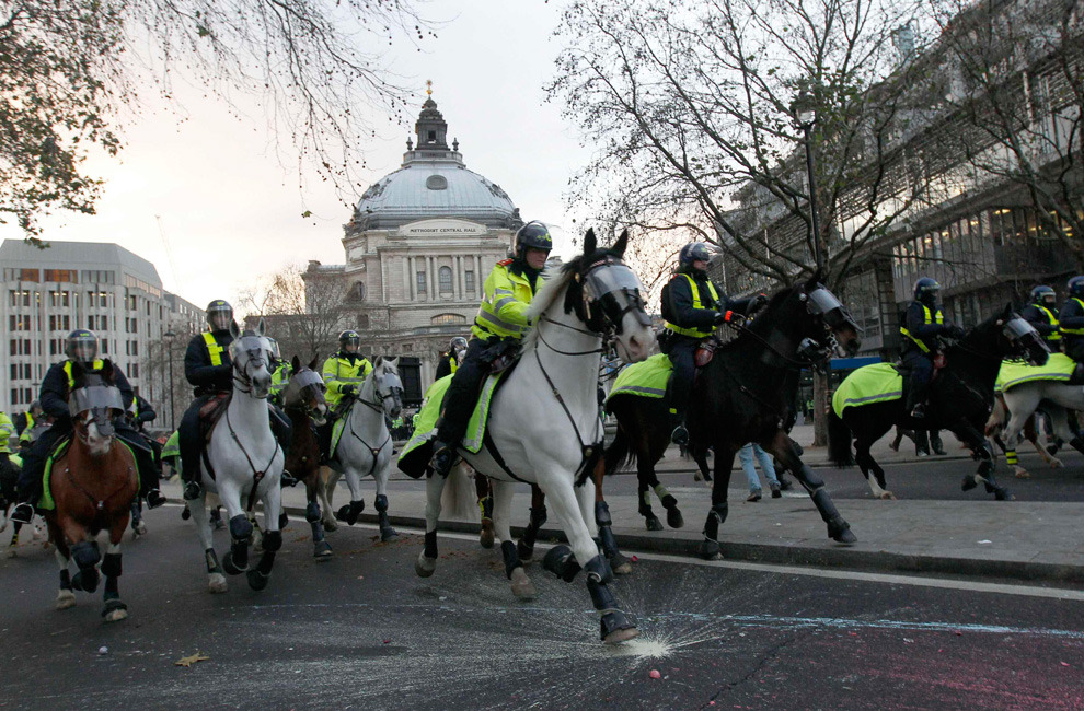  Mounted police ride during a protest in Westminster in central London December 9,