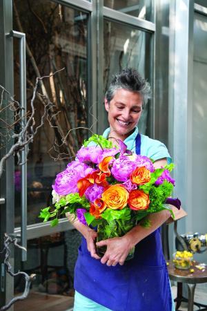 Artist Bella Meyer holds an abundant arrangement of roses, peonies, and calla lilies. Her work has been influenced by memories of her grandfather, artist Marc Chagall. Earlier in 2010, Meyer opened her new floral shop, Fleurs Bella, in New York...