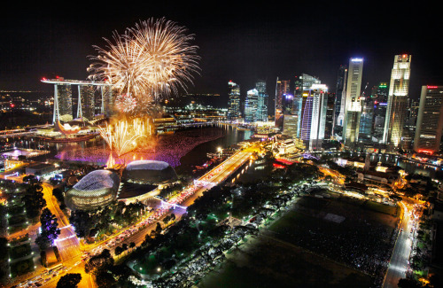 Fireworks explode above Singapore’s financial district at the stroke of midnight to mark the N