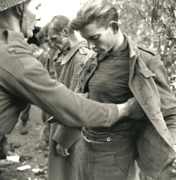 greatestgeneration:  Captured German soldiers being searched by Canadian soldiers December 9th, 1943 