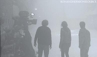 ronandhermionesource:  DEATHLY HALLOWS PART 2 Not EXACTLY sure when this is… but to me it looks like Diagon Alley.  EDIT: thanks nagaroboshi, you totally reminded me that this is probably Hogsmead.  Right before Aberforth takes them into safety. 