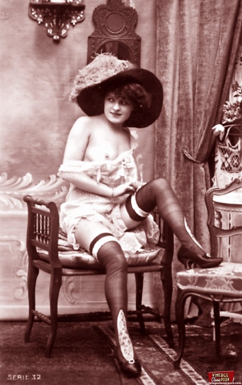 Vintage erotic photo of a topless girl in sexy hat