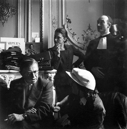 Jean-Paul Sartre and Maria Casarès, both smoking, during a fitting for costumes designed by E