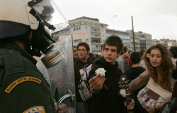 2008 Greek Riots - Athens: Young Students Offer Flowers To Riot Police While Others