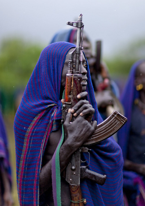 Another Surma warrior with his firearm.  He&rsquo;s at a Donga gathering, which is a brutal stick-fi