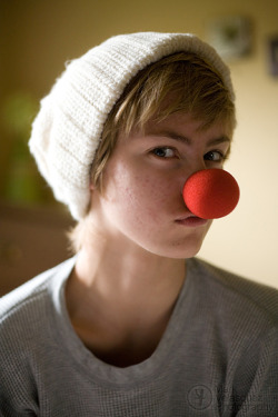 Jenna in bed with a clown nose on a Sunday