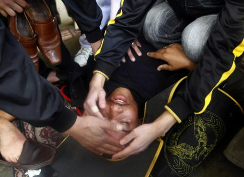Today, in one image.
In chaos, there is order: Egyptian rioters help an injured policeman in Cairo.
Photo by Yannis Behrakis (Reuters)