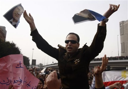 dailyme:  An army officer who joined anti-government protests tears up a picture of Egyptian President Hosni Mubarak, downtown Cairo, Egypt, Saturday, Jan. 29, 2011. (AP Photo/Ahmed Gumaa) 