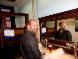  jason statham at a mensroom urinal 