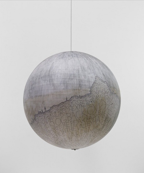 Artist and amateur astronomer Russell Crotty works on paper-covered globes and large books. He cover
