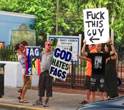 realcertified:  LMFAO At The ” Fuck This Guy ” Sign ! Haha  Are there two random dudes making out right behind the &lsquo;Fag Sin&rsquo; sign?