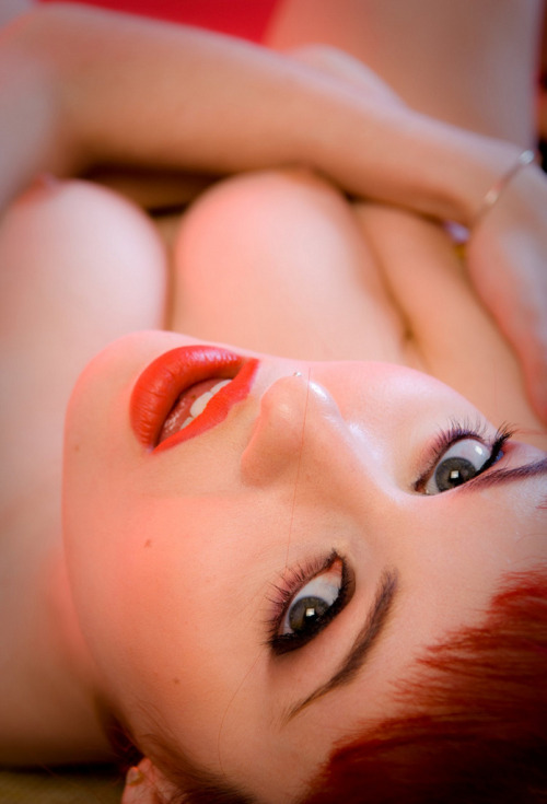 Lovely redhead lying down staring at you, porn pictures