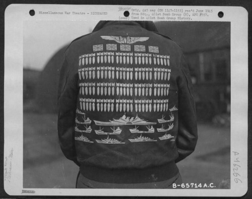 The mission marks on this jacket represent: 100 mission symbols, 5 Japanese flags (presumably fighte