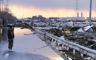 latimes:
“ A man looks over debris and mud filled rice paddies in Sendai, Japan. / Credit: Kyodo News / Associated Press
”
