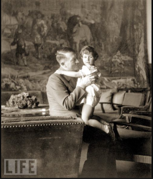 Hitler holds Ursula “Uschi” Schneider, the daughter of Herta Schneider, a close childhood friend of Eva Braun’s, at Hitler’s home in the Bavarian Alps, 1942.