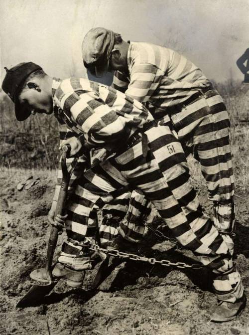 Prisoners in chains, working on the grounds of the prison in Georgia. Chain Gang. America. 1937.