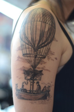 fuckyeahtattoos:  A symbol of my wanderlust and my love of old wood engravings. My cat, Grandpa, is in there too, just for fun. We mixed and matched images from a book about travel. Done by Alice Kendall at Infinity Tattoo in Portland, OR. It took about