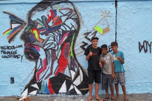 some boys in front of a graffiti