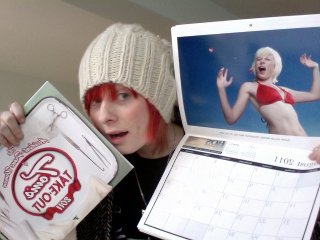 Sarah poses with her copies of my 2011 Accident-Prone Models Calendar showing her