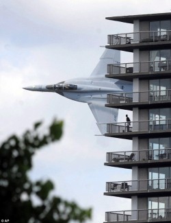 conflictingheart:  Flypast: The F18 streaks past an apartment block.