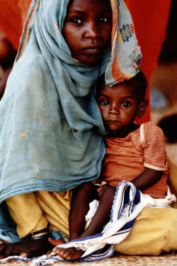 ixplosion:  Siblings Young girl with baby brother at feeding clinic in Khartoum, Sudan, 1987. 