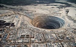 dylanforsberg:  The Mirny Diamond Mine in Russia is the world’s biggest hole - it’s 525 meters deep and 1.25km wide.The suction above the hole resulted in several helicopter crashes, so all flight above the hole is now prohibited. (via) 