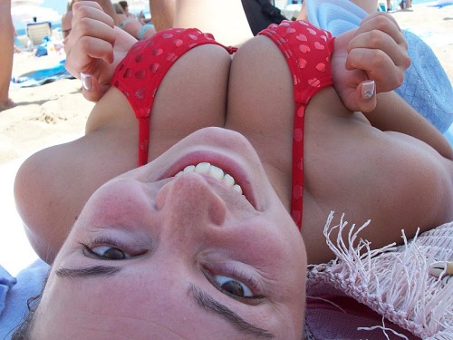 badmanbadplace: Woman squeezes rack on the beach While my girlfriends like to float on water using t