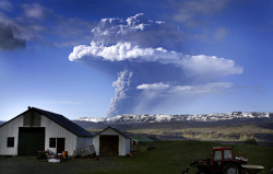 A cloud of smoke and ash is seen over the