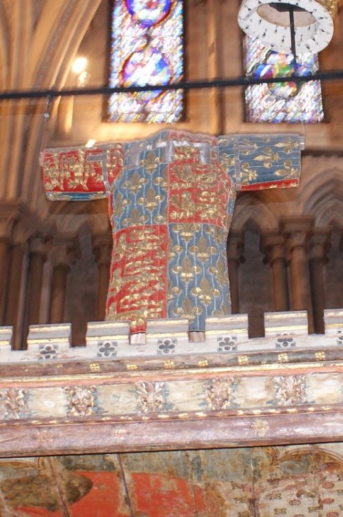 The recreated surcoat of the Black Prince hanging over his tomb in Canterbury CathedralThe original 