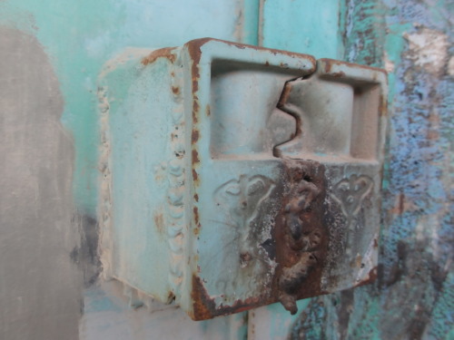 A storefront lock on the former main street in Hebron. It is welded shut.