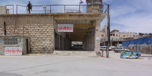 Back in the sterilized streets, signs placed by Israeli settlers in Hebrew and English read, &ldquo;