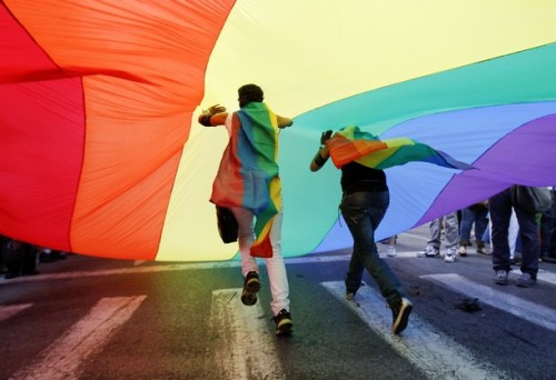 greekdude: Protesters run under a huge flag during the Athens Pride Parade in Athens June 4, 2011. (