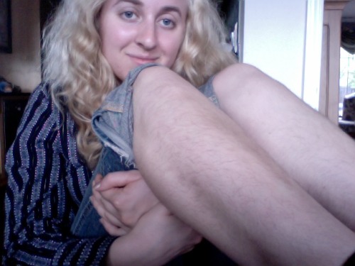 hairylegsclub:  [Image: A light-skinned blonde girl sitting and hugging her legs to her chest, her h