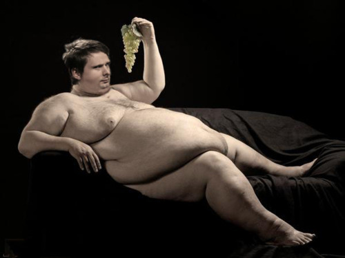 Fat man with grapes