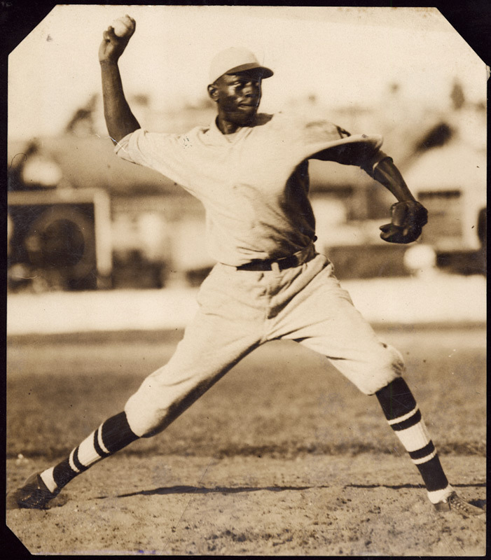 A photo of Satchel Paige, St. Louis Browns pitcher, reading a