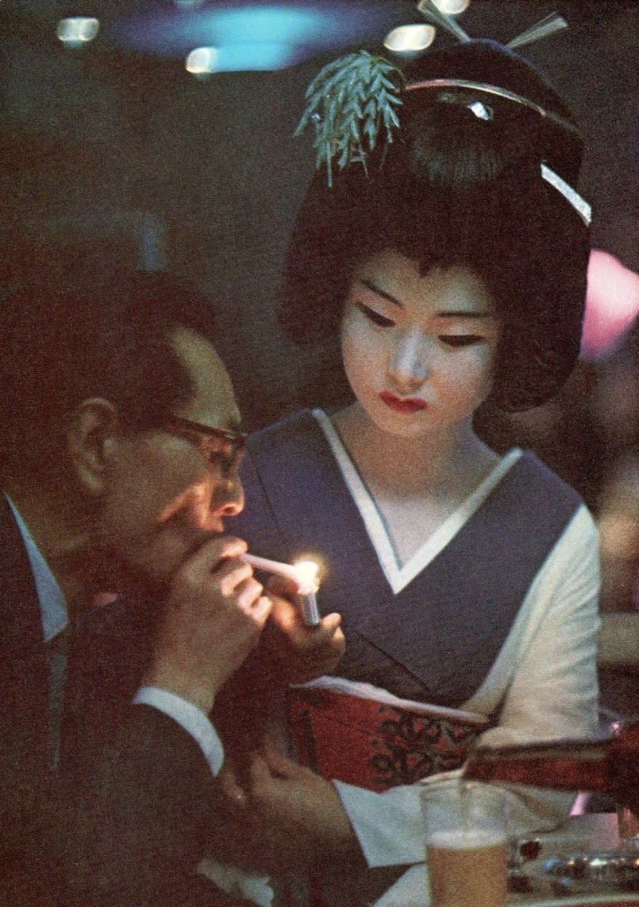 crazy70s:  Geisha presents a light to a diner in a Tokyo restaurant, 1969 