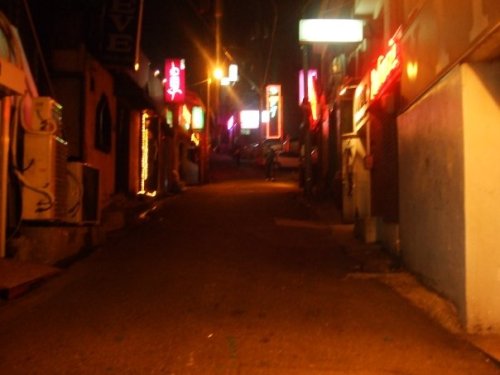 loisuh: Hooker Hill, Itaewon. A whole street full of brothels masquerading as bars. Men walking up h