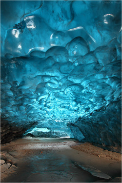  This up to 1000 years old snow has metamorphosed into highly pressurized glacier ice that contains almost no air bubbles. Thus it absorbs the visible light despite the scattered shortest blue fraction, giving it its distinct deep blue waved appearance.