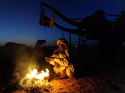 nationalgeographicdaily:  Camel Trader, India Photograph by Alison Harbaugh Rising before the sun, a lone camel trader sits near his fire to keep warm while he waits for the day of trading to begin at the Nagaur Cattle Fair in Nagaur, India.
