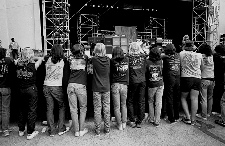 boo-sem-ee:  Line of heavy metal heads watching band on stage (1984) 