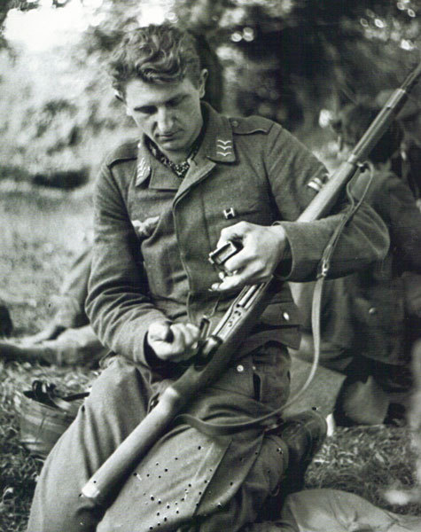 A Fallschirmjager Obergefreiter spotted without his smock cleaning his 7.92mm Gewehr 41 semi-auto ri