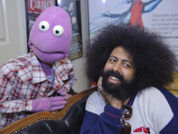 A cute Reggie Watts poses for a pinup calendar