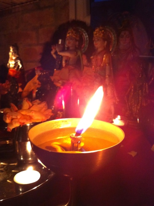 Altar in a Mauritian home. Next to Hindu deities, there are also pictures of Jesus and Mary, a resul