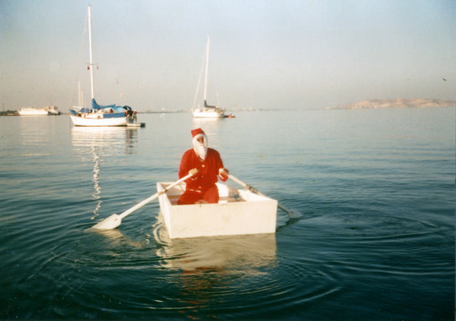 Santa Claus goes visiting the children on yachts, swapping a boxy plywood dinghy for his sleigh.