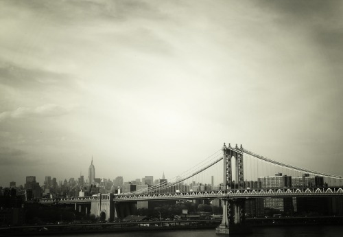 nythroughthelens:  The Manhattan Bridge and the New York City skyline in black and white. New York City. Buy “Manhattan Bridge” Posters and Prints here, View my store, email me, or ask for help. “…To him, no matter what the season was, this was