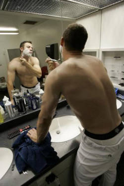 Texas Rangers&rsquo; Rich Harden shaving in the locker room.