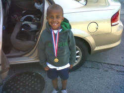 Amin and his first kiddie marathon medal.