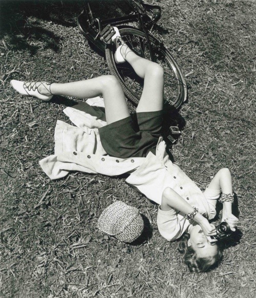 theniftyfifties:A girl in the park with a bike and her camera.  Photo by Louise Dahl-Wolfe, 1952.