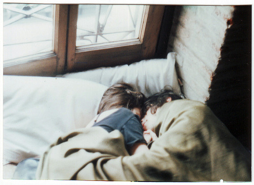 Couple sleeping under blanket